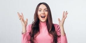 Woman excitedly throwing hands up